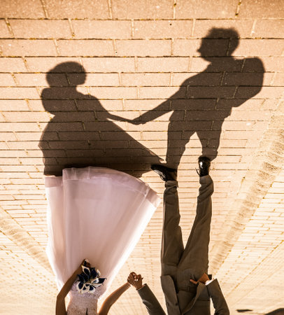 Shadow of posing wedding couple on groundの写真素材