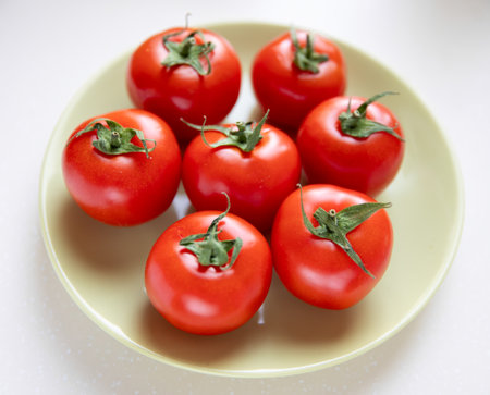 Group of whole tomatoes on plateの写真素材