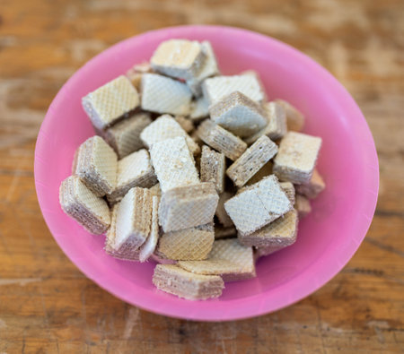 Heap of wafer biscuits in pink bowlの写真素材