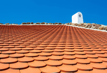 Red tiled roof at blue skyの写真素材