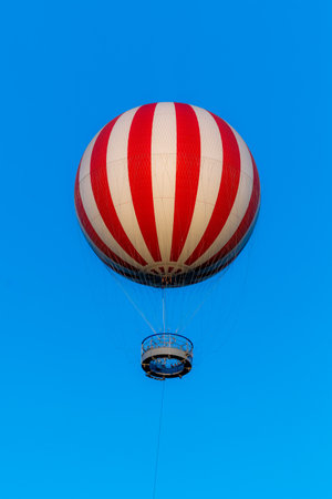 Stripped air balloon fly in blue skyの写真素材