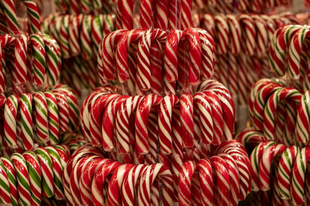 Arrangement of sweet striped lollipops in shop