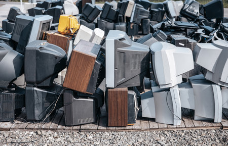 Heap of electronical appliances waste, monitors and TVs