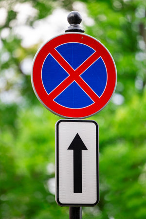 No stopping road sign with arrow