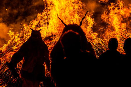 Silhouette of a monster in front of a huge fire