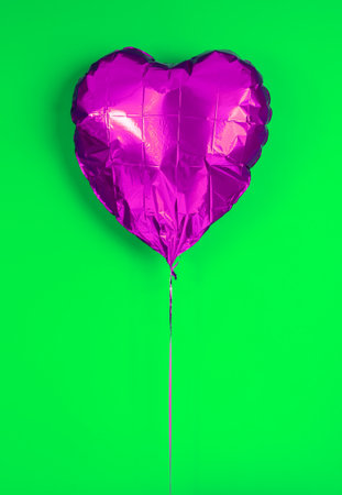 Colorful foil heart shaped on colorful backgroundの写真素材