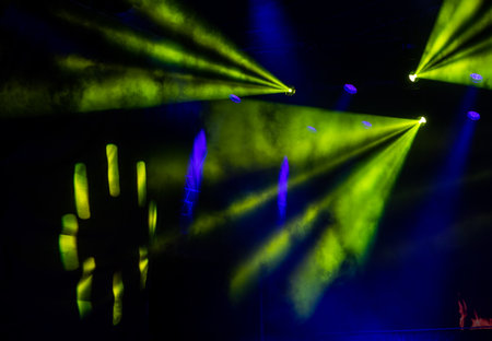 Green light beams on dark background