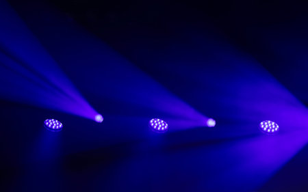 Stage spotlights with dramatic light beams in smoke