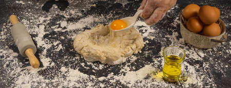homemade bread dough with flour, salt, egg, water and yeast, with a black backgroundの写真素材