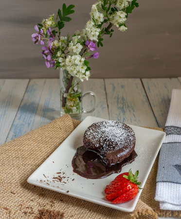 chocolatecoulant with strawberries with flower background sweet dessertの写真素材