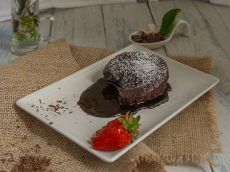 chocolatecoulant with strawberries with flower background sweet dessertの写真素材