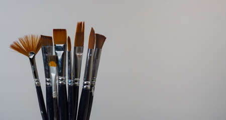 artistic brushes with colored oil on white background painter toolsの写真素材