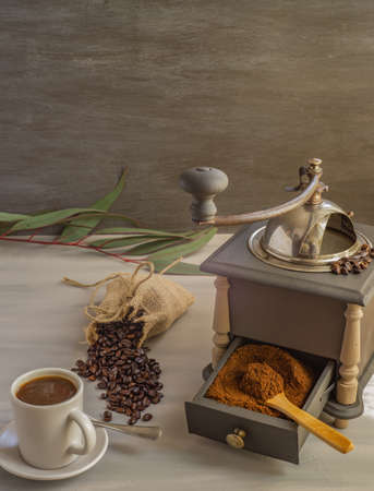 coffee beans and ground coffee with coffee grinder and flowersの写真素材