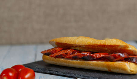 chorizo sandwich and olive tapa on black slateの写真素材