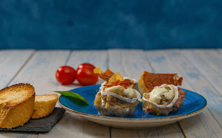 mushrooms stuffed with goat cheese, ham and cherry tomatoesの写真素材