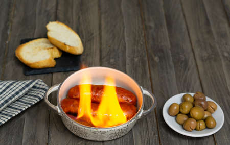 spicy chorizo to hell cooked over a fire right on the tableの写真素材
