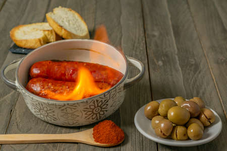 spicy chorizo to hell cooked over a fire right on the tableの写真素材