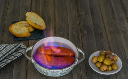 spicy chorizo to hell cooked over a fire right on the tableの写真素材