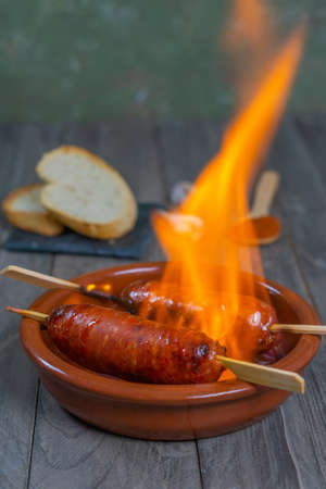 spicy chorizo to hell cooked over a fire right on the tableの写真素材