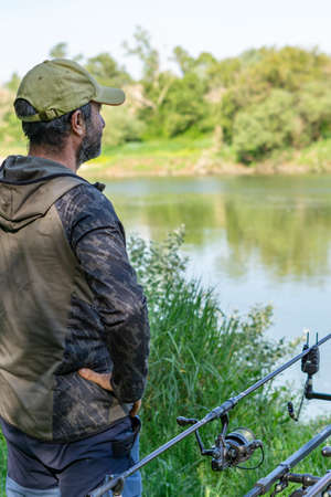 fishing session in the ebro river adult man with beard carp fishing
