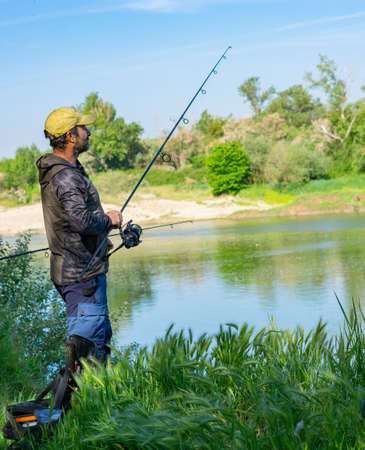 fishing session in the ebro river adult man with beard carp fishingの写真素材
