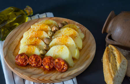 boiled potato chorizo and rosemary oil on a dark backgroundの写真素材