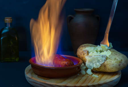boiled potato chorizo and rosemary oil on a dark backgroundの写真素材