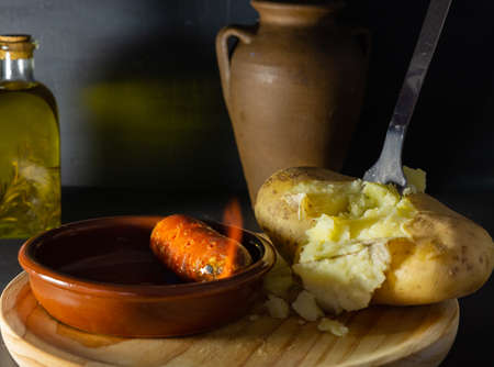 boiled potato chorizo and rosemary oil on a dark backgroundの写真素材