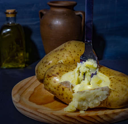 boiled potato chorizo and rosemary oil on a dark backgroundの写真素材
