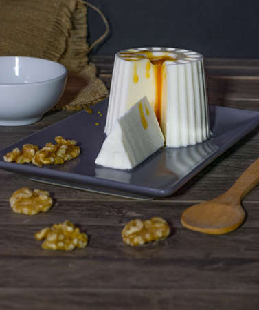 fresh cheese with honey and walnuts with different containers and backgroundsの写真素材