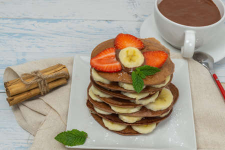 cocoa pancakes with strawberries and bananasの写真素材