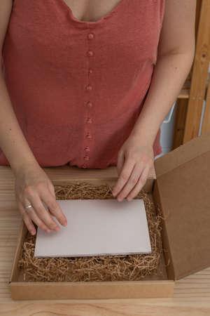 young artisan woman working in her ecological notebook workshopの写真素材