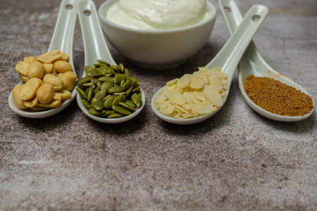 yogurt with nuts, almonds, peanuts and pumpkin seedsの写真素材