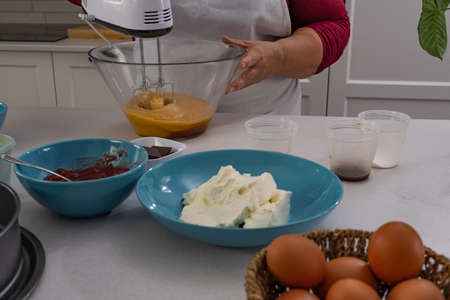 process of making a strawberry cake in a white kitchen all ingredientsの写真素材