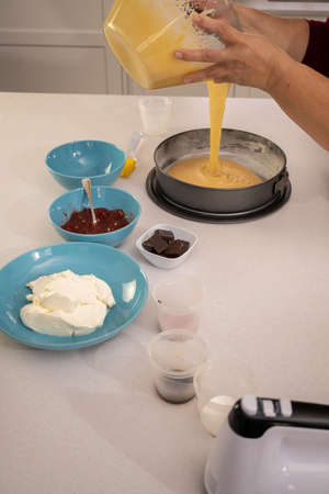 process of making a strawberry cake in a white kitchen all ingredientsの写真素材