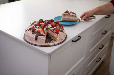 process of making a strawberry cake in a white kitchen all ingredientsの写真素材