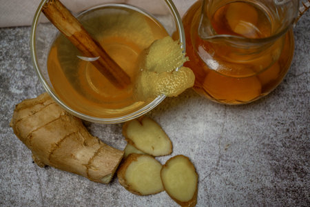 preparation of a ginger and cinnamon infusion with fresh produce natural roots and cinnamon stick...