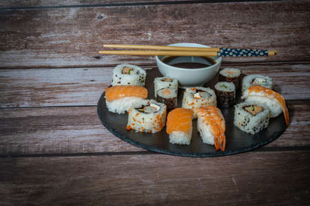 close-up of sushi sashimi with chopsticks and soybeans, with different backgroundsの写真素材