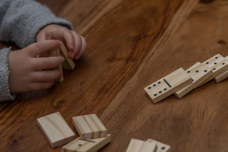 wooden dominoes in a row on a wooden tableの写真素材