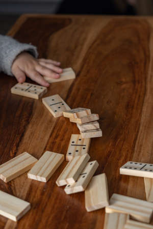 wooden dominoes in a row on a wooden tableの写真素材