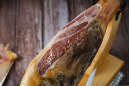 plate of spanish acorn-fed iberian ham in the foreground with bread and wine typical spanish appetizerの写真素材