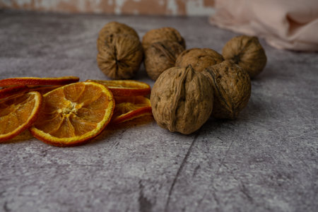 dried orange with walnuts in the background out of focus