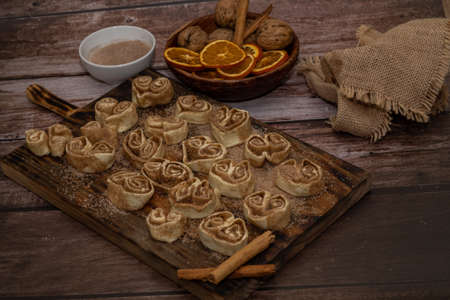 whole cinnamon and sugar roll ready to cut and bake on a white baking trayの写真素材