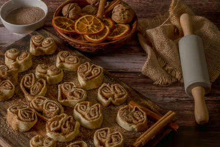 whole cinnamon and sugar roll ready to cut and bake on a white baking trayの写真素材