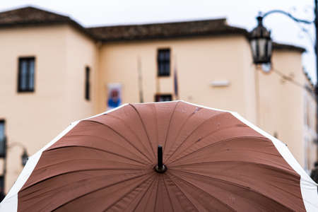 wet umbrella with building in the background and copy space