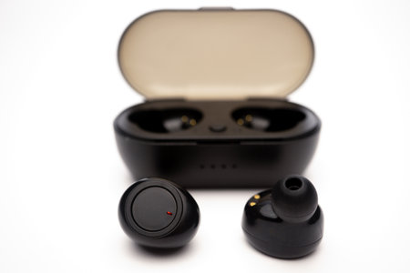 wireless headphones black color with box and charger on white background and copy spaceの写真素材