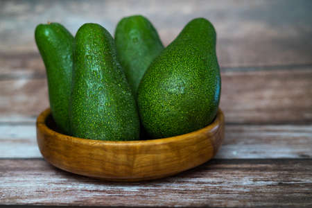 organic avocado from sustainable agriculture from andalucia, spain on a wooden board and on a raffia clothの写真素材