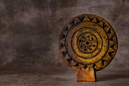 close-up of a hand-carved and hand-painted stone disc, Aztec handicraft, isolatedの写真素材