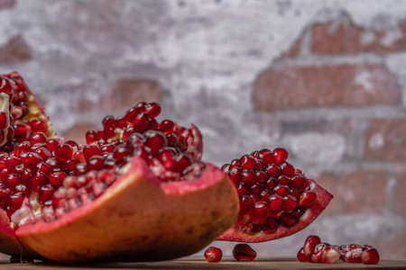 close-up of open pomegranate, fresh red seeds with out-of-focus backgroundの写真素材