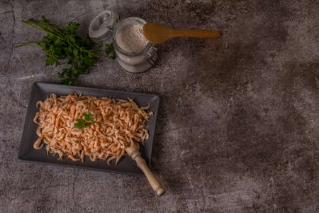fresh shrimps in a ceramic tray with parsley, flour and onion